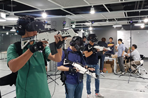 VR기기와 총기모형을 착용 후 체험을 진행중인 사진